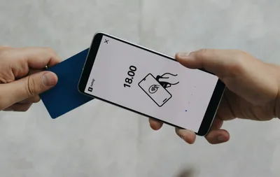 A person holding a cell phone in their hand