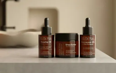 Three skincare bottles and jar on counter