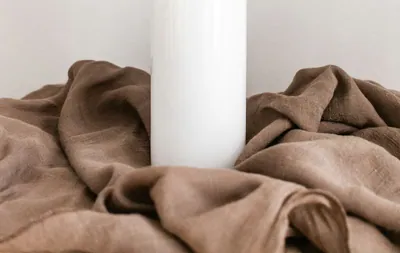white plastic bottle on white table