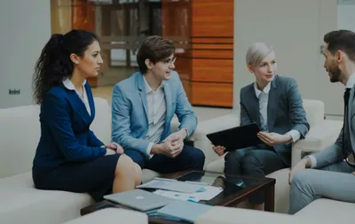 Four business people in a meeting discussing documents
