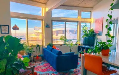 a living room filled with furniture and lots of windows