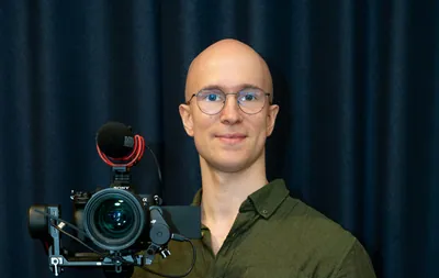 Man holding professional video camera with stabilizer